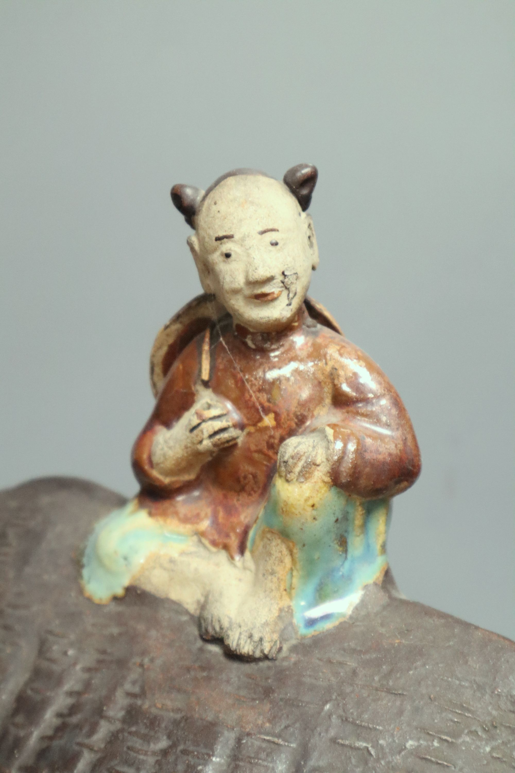 A large Chinese pottery group of a man riding an ox, Guandong kilns, height 40cm